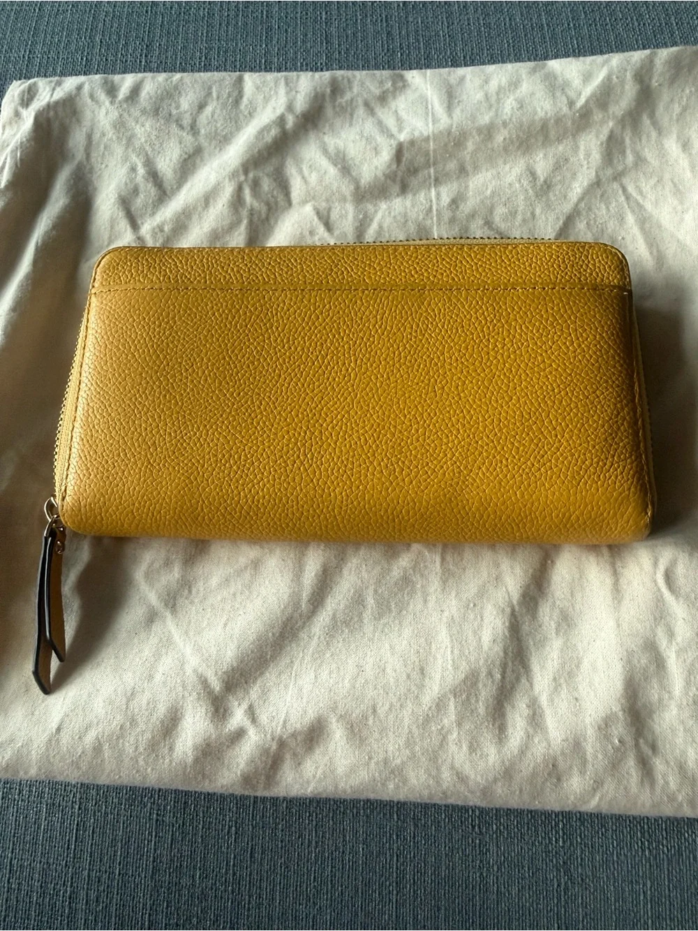 kate spade New York yellow zip-around pebbled leather wallet